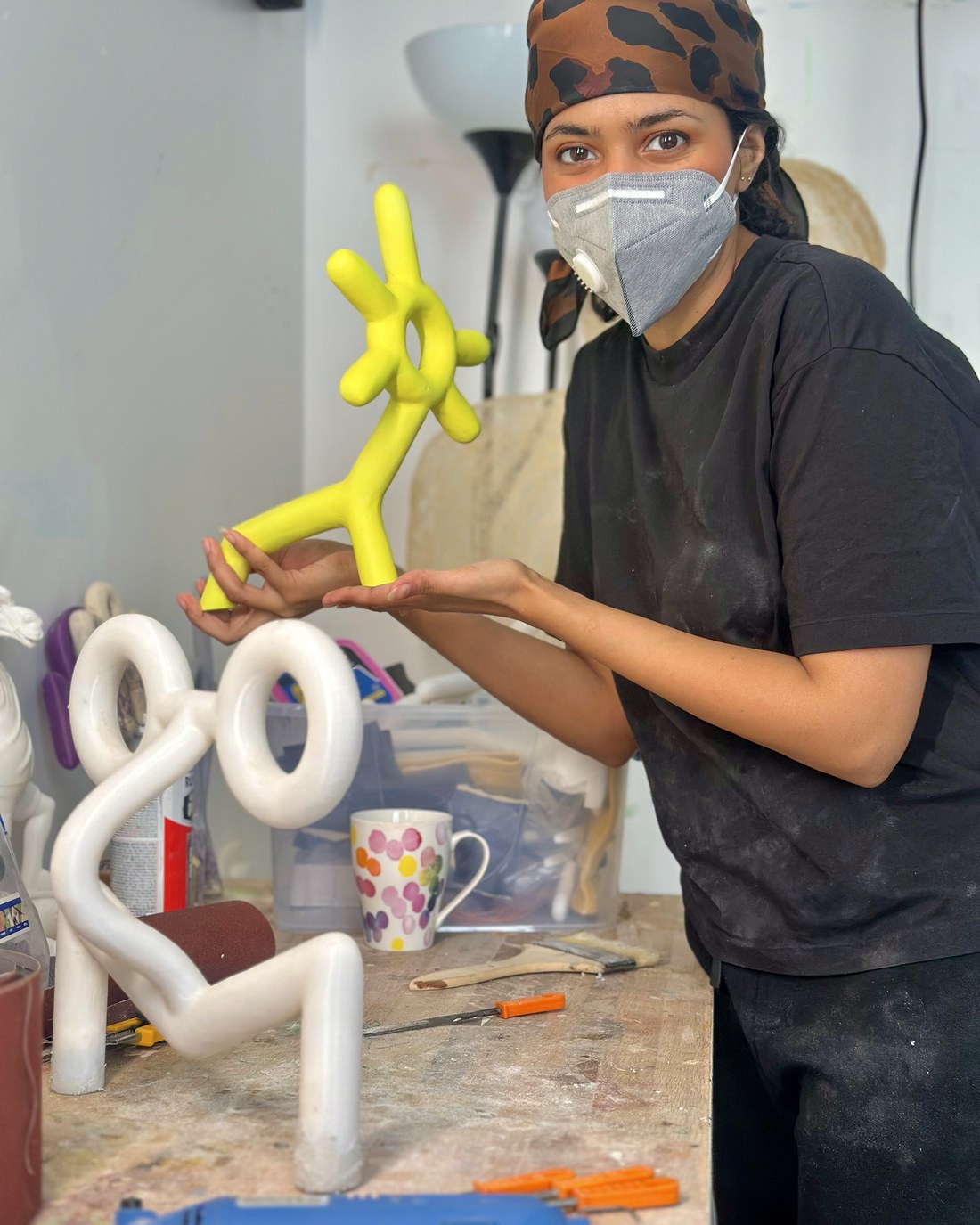 Marya Mayan in her studio holding a yellow ONS sculpture